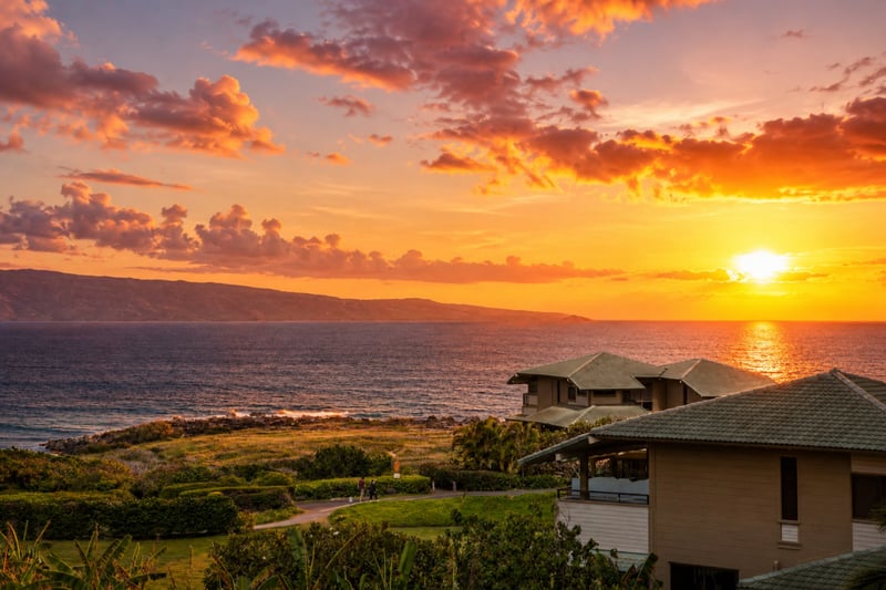 Maui sunset over The Resort at Kapalua Bay — golden-hour views of the Pacific and West Maui coastline from the property grounds