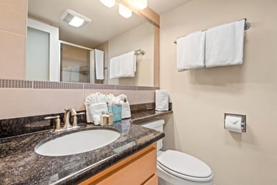 A well-appointed master bathroom featuring a dual-view vanity, plush towels, and thoughtful amenities for daily ease