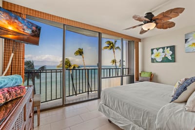 Wake to ocean breezes in this serene master suite with a plush king bed and panoramic lanai views of paradise beyond