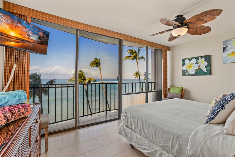 Wake to ocean breezes in this serene master suite with a plush king bed and panoramic lanai views of paradise beyond