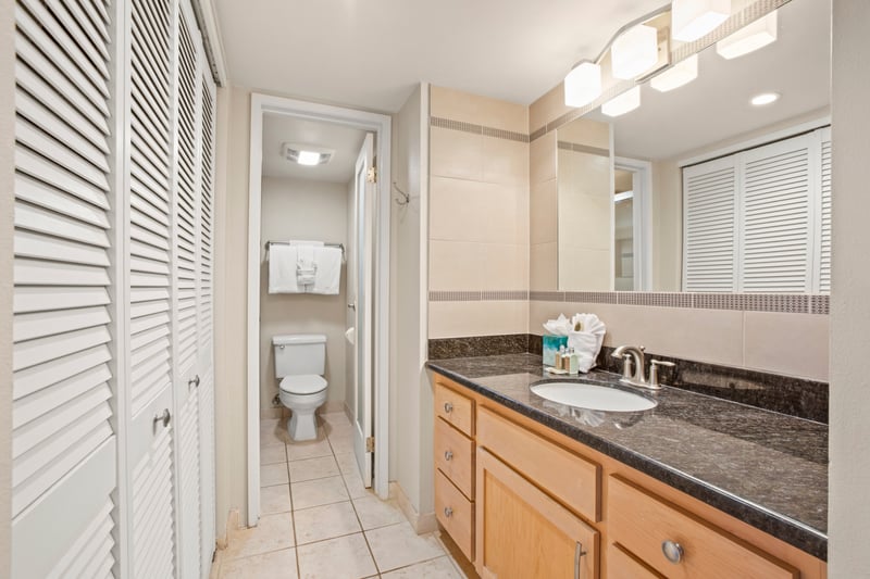 Enjoy the luxury of a master bathroom where polished countertops, ample mirrors, and modern fixtures meet classic charm