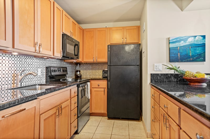 This modern kitchen offers everything you need—sleek appliances, rich wood cabinetry, and coastal charm throughout
