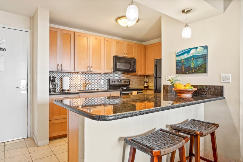 Whip up meals or sip coffee at the breakfast bar in this warm, well-appointed kitchen with island flair and comfort