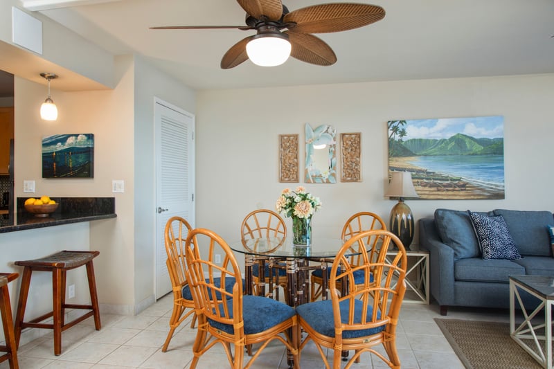 Savor island meals in a light-filled, rattan-accented dining space that blends relaxed luxury with tropical artistry