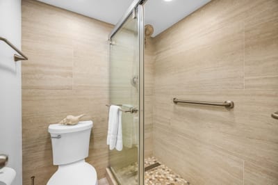 A walk-in shower with glass enclosure and clean tile finishes completes the master bath VIR-107
