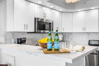 The recently updated white cabinets and stainless appliances give the kitchen a clean, well-appointed feel VIR-107