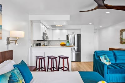 A breakfast bar with seating for three makes casual mornings easy, right off the fully equipped kitchen VIR-107