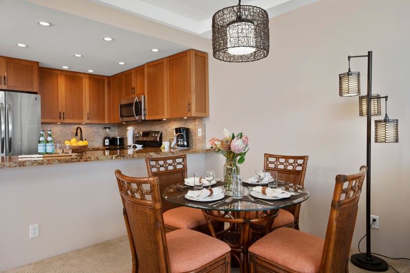 Enjoy intimate meals at a beautifully set table with island florals, woven textures, and soft, ambient lighting WH1-1211