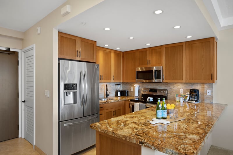 This gourmet kitchen blends rich wood cabinetry, granite countertops, and sleek stainless steel appliances with ease WH1-1211
