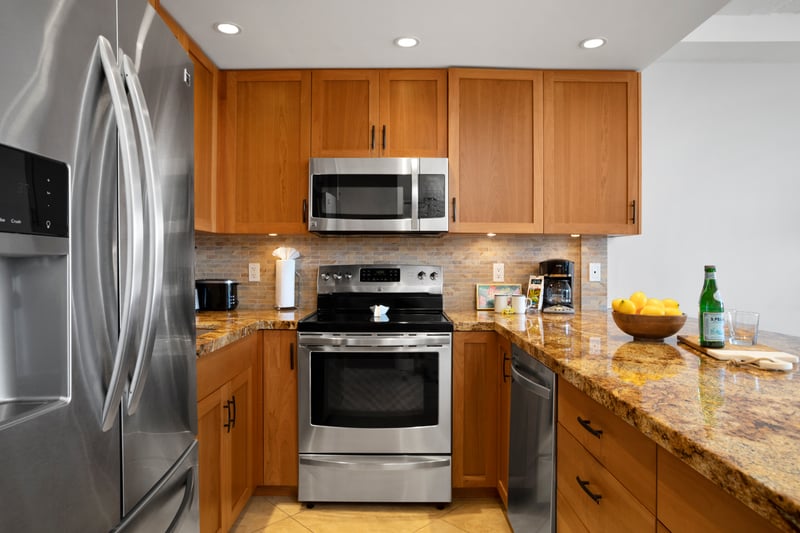 Cook in style with warm granite counters, modern lighting, and high-end stainless steel appliances throughout WH1-1211
