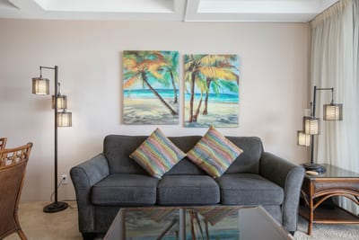 Bright pillows, rattan charm, and a front-row seat to the ocean’s sparkle—this space is island magic come alive