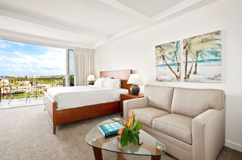 A suite made for sunshine seekers—chic neutrals, lush florals, and balcony views that dance with ocean light