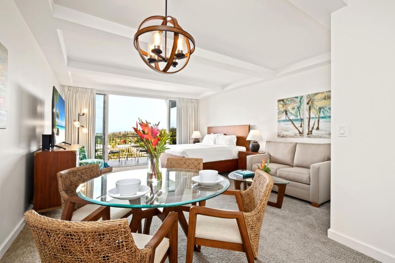 Enjoy open-concept dining with tropical florals, beach-inspired art, and seamless views into the relaxing living space