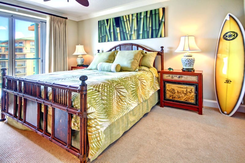 Vibrant surf-inspired bedroom design with queen bed, custom decor, and natural light for a breezy island feel