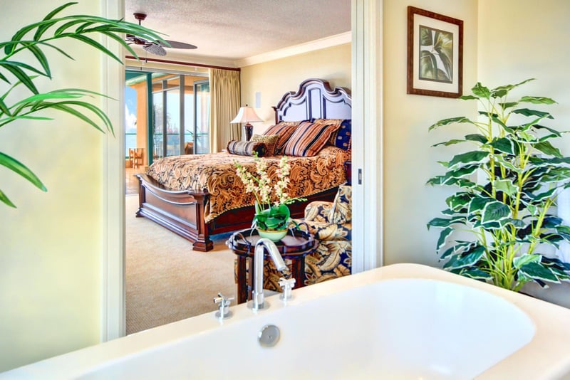 Private retreat with soaking tub and tropical garden views, creating a serene and indulgent master sanctuary