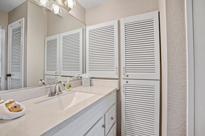 Crisp whites, natural light, and thoughtful touches—this cheerful bathroom is your personal slice of coastal calm