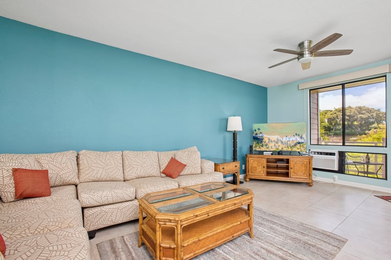 Cozy open-concept living area with a sectional sofa and easy access to the lanai