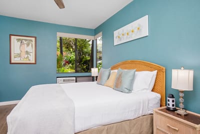 The master bedroom features vibrant island decor and soft natural light