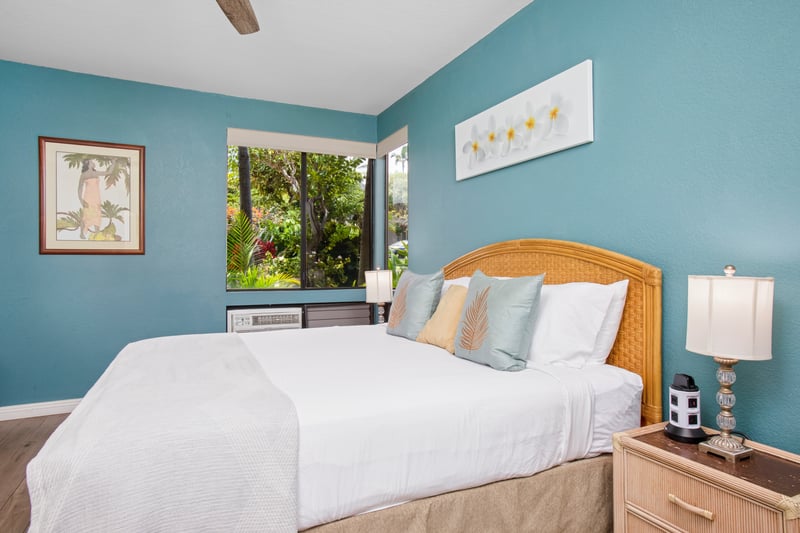 The master bedroom features vibrant island decor and soft natural light
