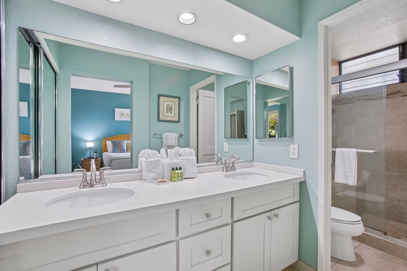 The master bath features a double vanity and luxurious amenities