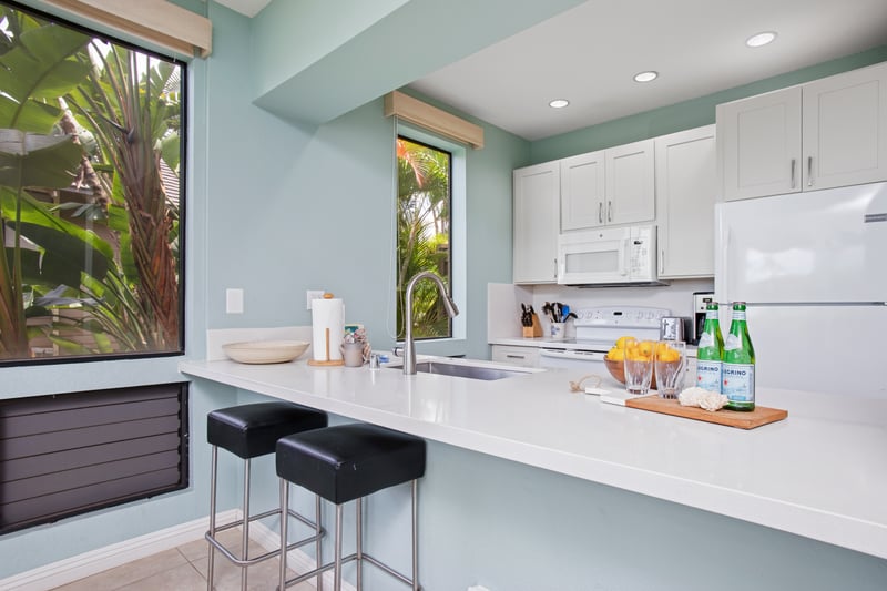 Fully equipped kitchen with island seating and modern white cabinetry