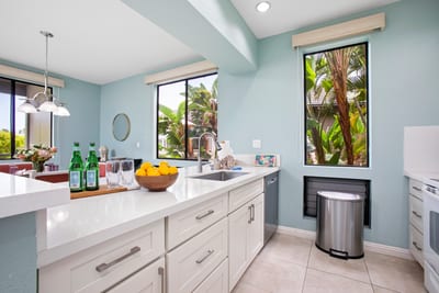 Airy kitchen and dining layout with large windows and tropical ambiance