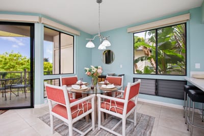 Bright dining nook surrounded by windows and garden views
