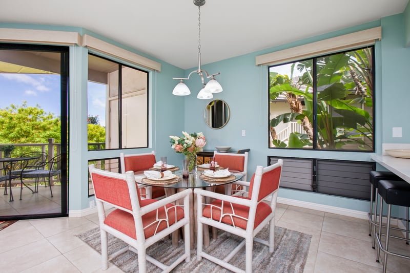 Bright dining nook surrounded by windows and garden views