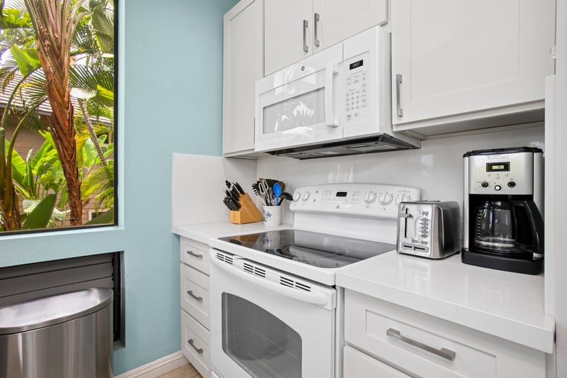 Kitchen stocked with essentials including full-size appliances and coffee maker