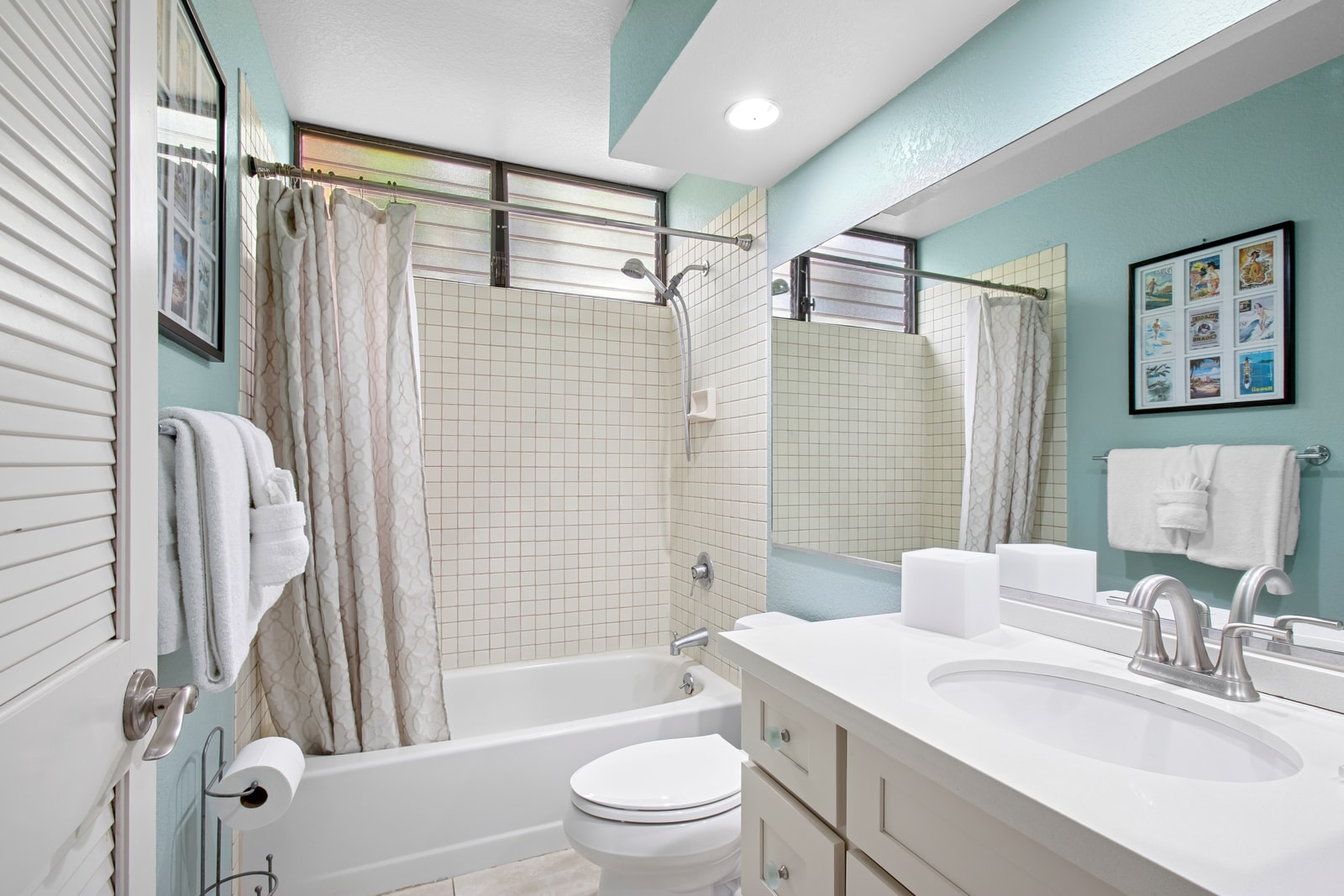 The guest bath features a shower tub combo and classic white finishes