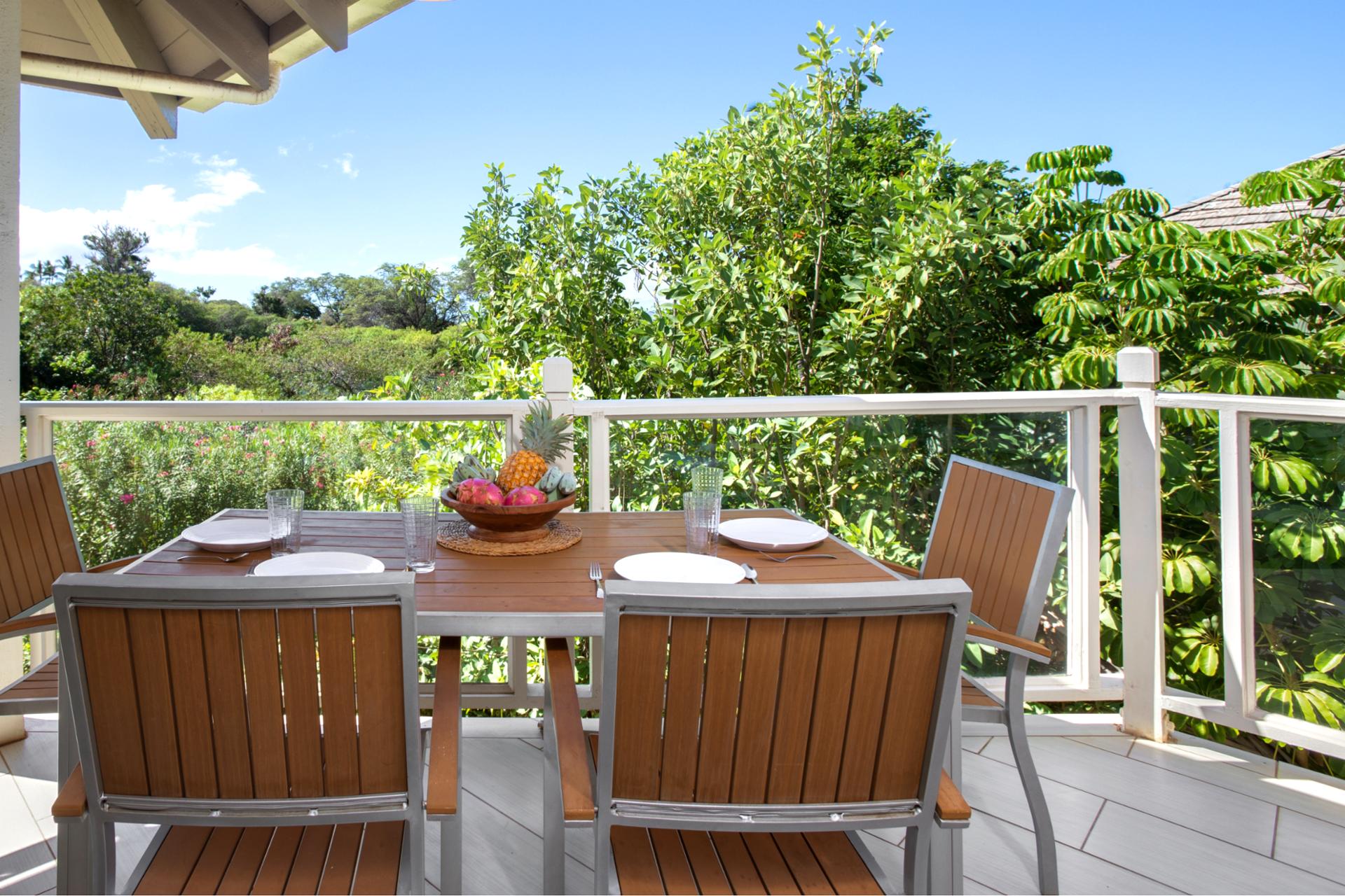 Enjoy a tropical al fresco meal surrounded by lush greenery and vibrant island vibes on this serene lanai retreat.