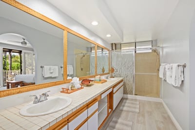 Unwind in the spa-inspired guest bath with dual sinks and a large glass walk-in shower