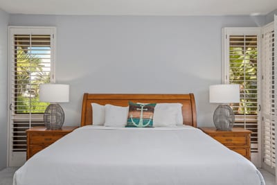Retreat to the serene master suite featuring a plush king bed and calming natural tones