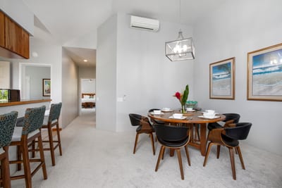 Gather around this elegant dining table beneath soft lighting for memorable meals with loved ones