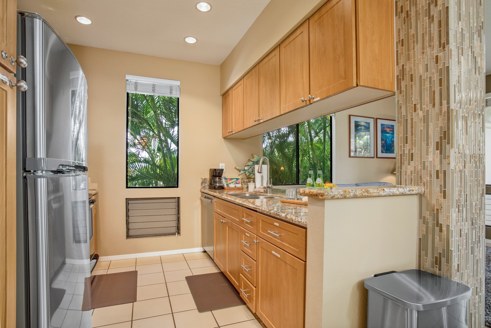 Functional kitchen with sleek countertops and natural light