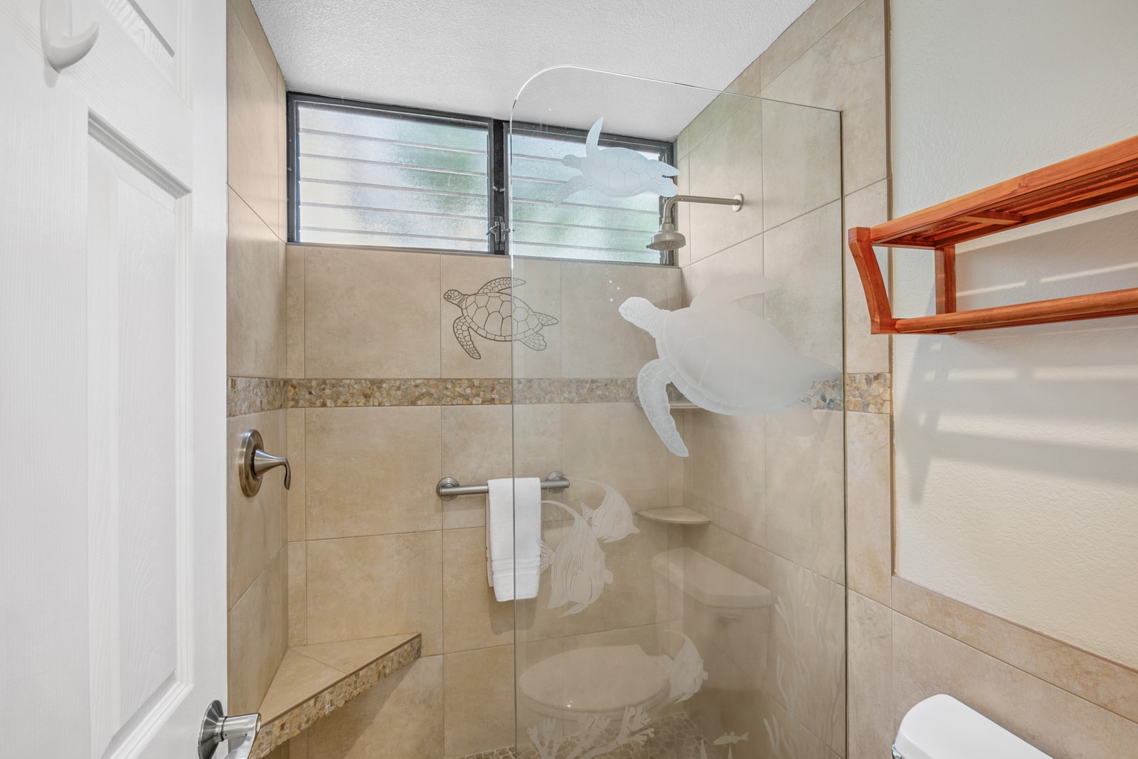 Master bathroom with tiled walk-in shower and fresh towels