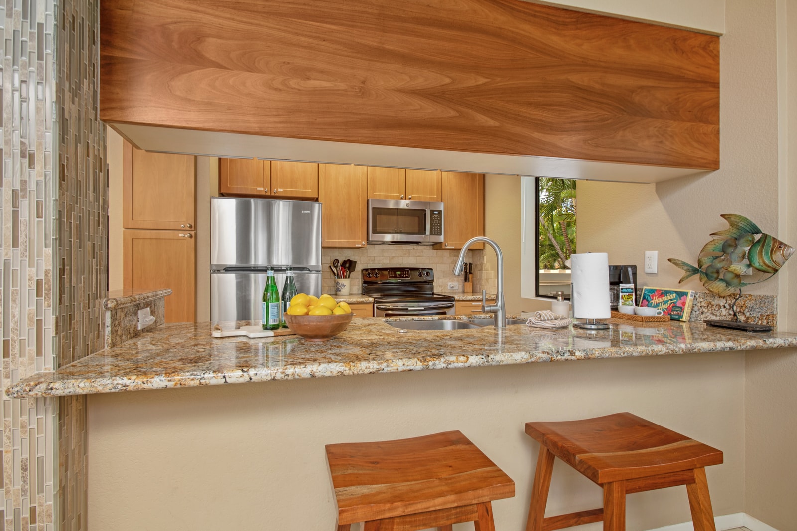 Bright kitchen with breakfast bar and wood cabinetry