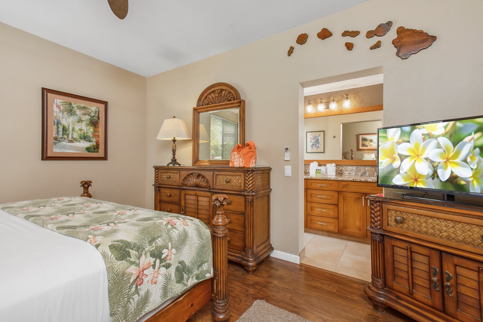 Spacious master suite with island-style furnishings and a flat-screen TV