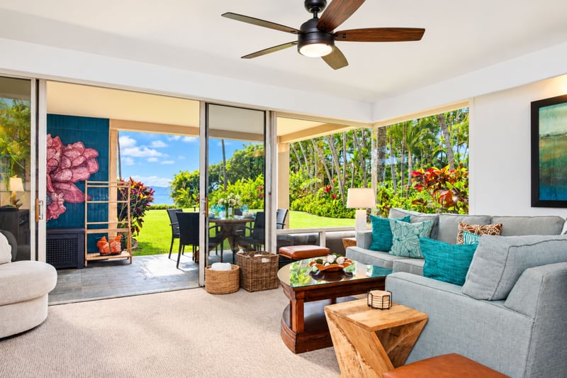 Spacious and light-filled living areas offer plush seating, ceiling fans, and large windows with garden views, ideal for relaxing after a day in the sun.