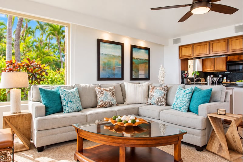 Spacious and light-filled living areas offer plush seating, ceiling fans, and large windows with garden views, ideal for relaxing after a day in the sun.