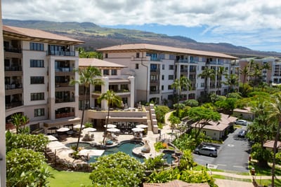 Gaze out over a resort dreamscape where palm trees pose, pools glisten, and the ocean peeks in like a shy admirer