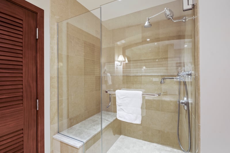 The walk-in shower’s tile glows like sun-warmed sand, and the built-in bench says, “Yes, sit and stay awhile.”