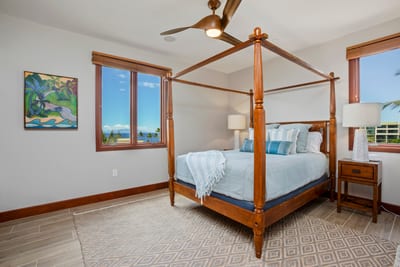 Drift off beneath a regal queen-sized canopy bed that feels straight out of a breezy island fairy tale