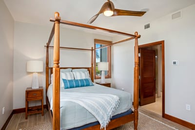 Golden light spills through twin windows, warming the queen bed like nature's personal turndown service