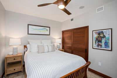 The wooden ceiling fan hums lullabies overhead while the queen bed whispers, “cancel your plans and nap instead.”