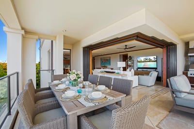 The view stretches out like a lazy Sunday, with rooftops and ocean waves napping beneath a tropical sky