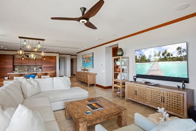 Wrapped in soft neutrals and trimmed in honeyed wood, this living room is a beachfront daydream in linen and light