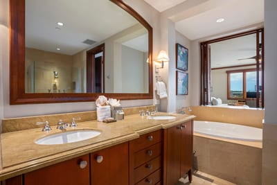 Dual sinks and a long counter make room for everything: your skincare routine, beachy souvenirs, and zen vibes