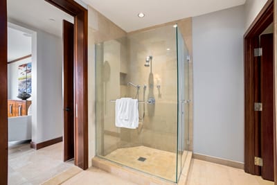 The walk-in shower’s tile glows like sun-warmed sand, and the built-in bench says, “Yes, sit and stay awhile.”
