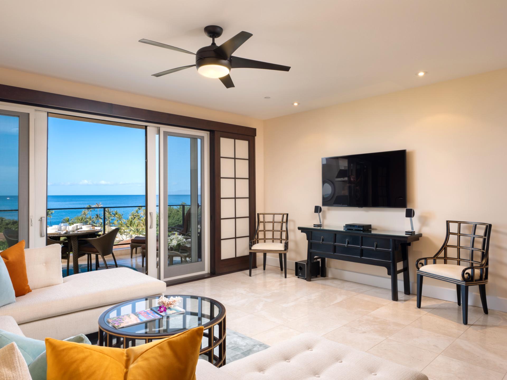 Gather in the open living area, featuring a large Smart TV and direct lanai access, for seamless indoor-outdoor flow.